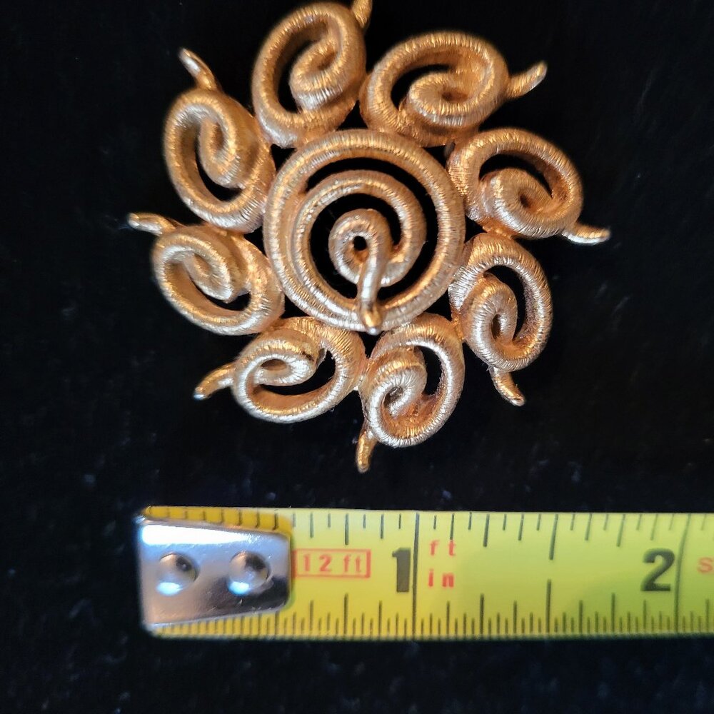 Gold-Tone Swirl Pin Marked Monet. 1-5/8" Wide. Like New Condition